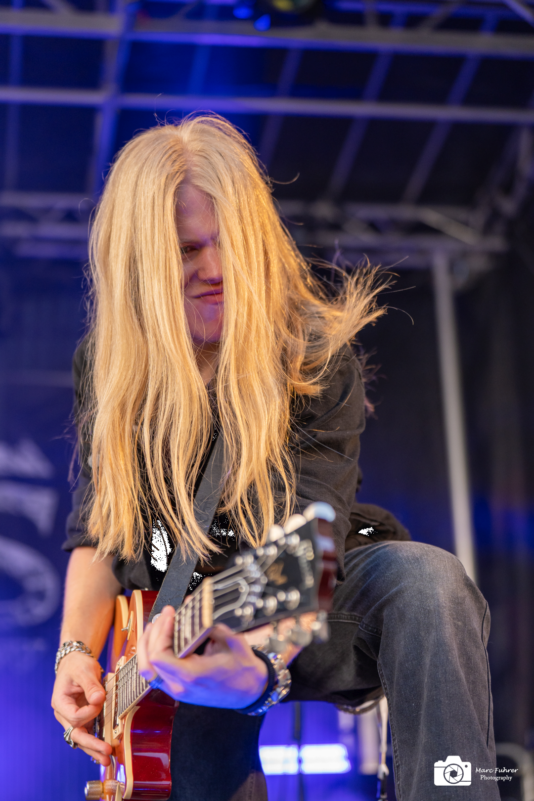 Guitarist Roman Fäh performing live on stage with INOXIUS